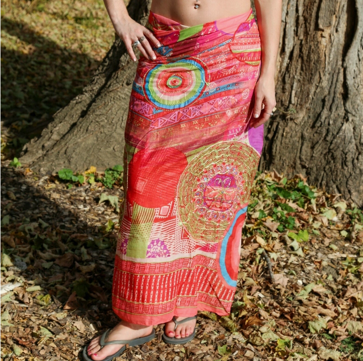 Sarong, bright orange, reds, fuschia, and purple, shown tied in the back