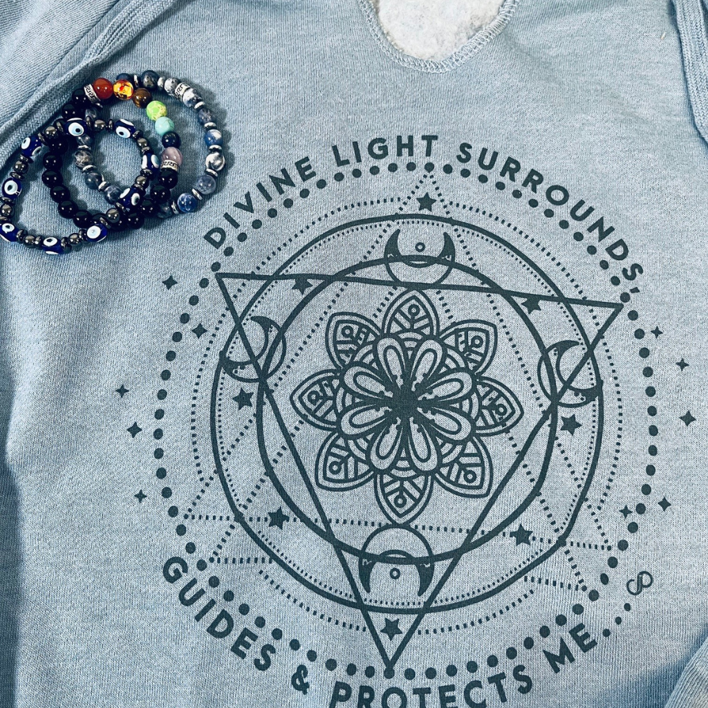 "Divine Light Surrounds, Guides, & Protects Me" - V-Notch Fleece Hoodie. Close Up with Chakra Bracelets