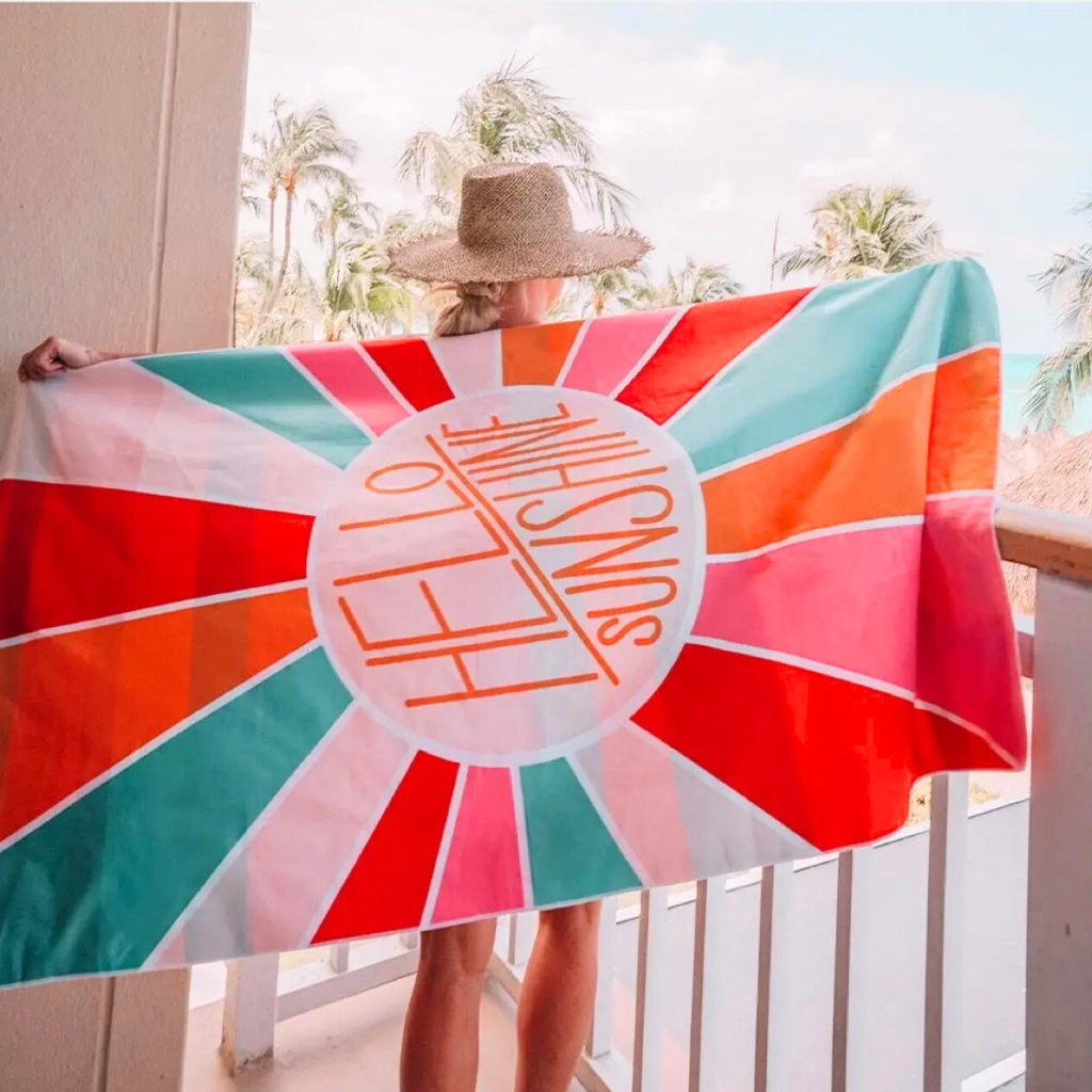 "Hello Sunshine" -Double-sided , Quick Dry, Microfiber Beach Towel. Shown with Lady Holding Towel, Shows Full Design.