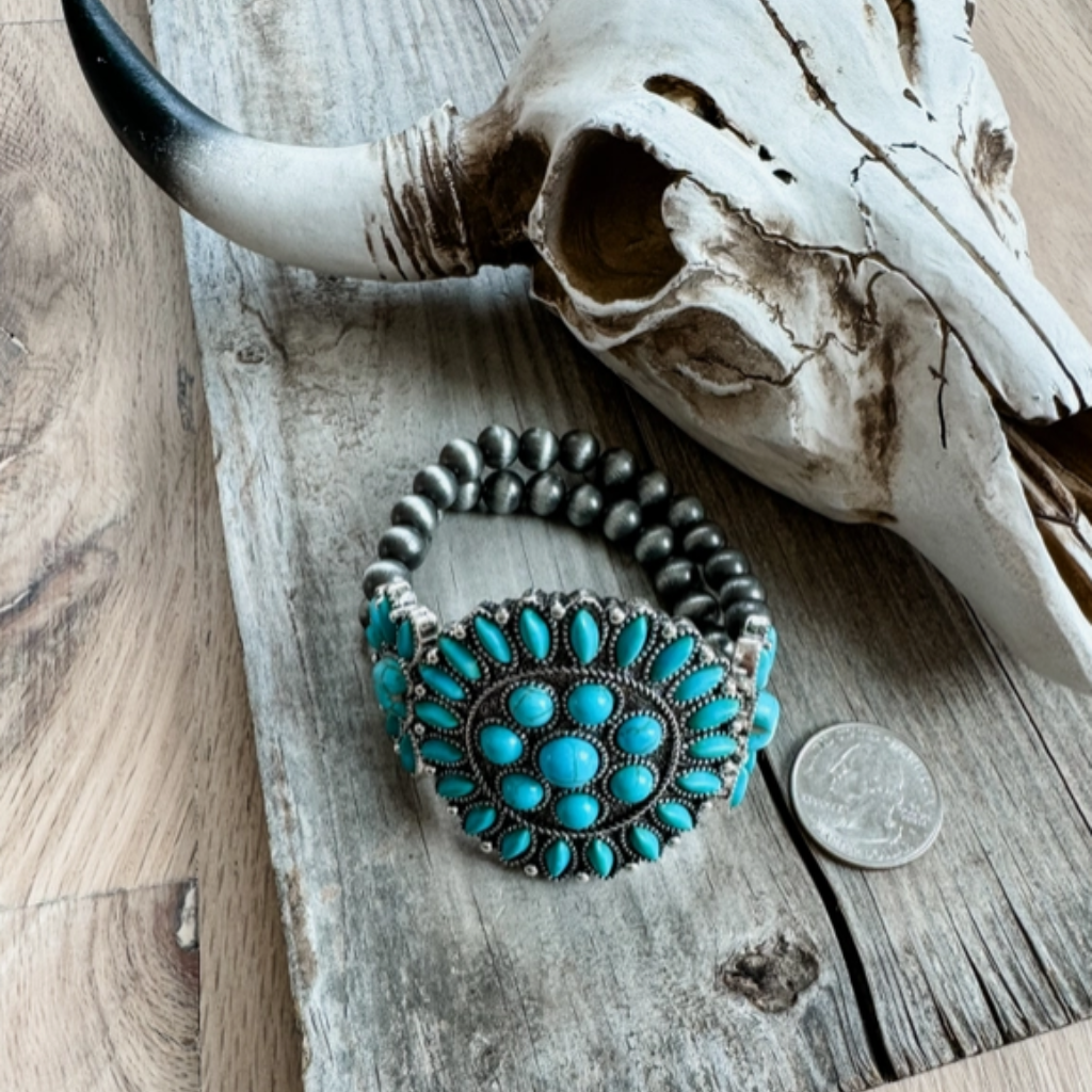 Western Boho Style Stretch Bracelet - Turquoise Stones with Burnished Silver Beads. Side View on Weathered Board